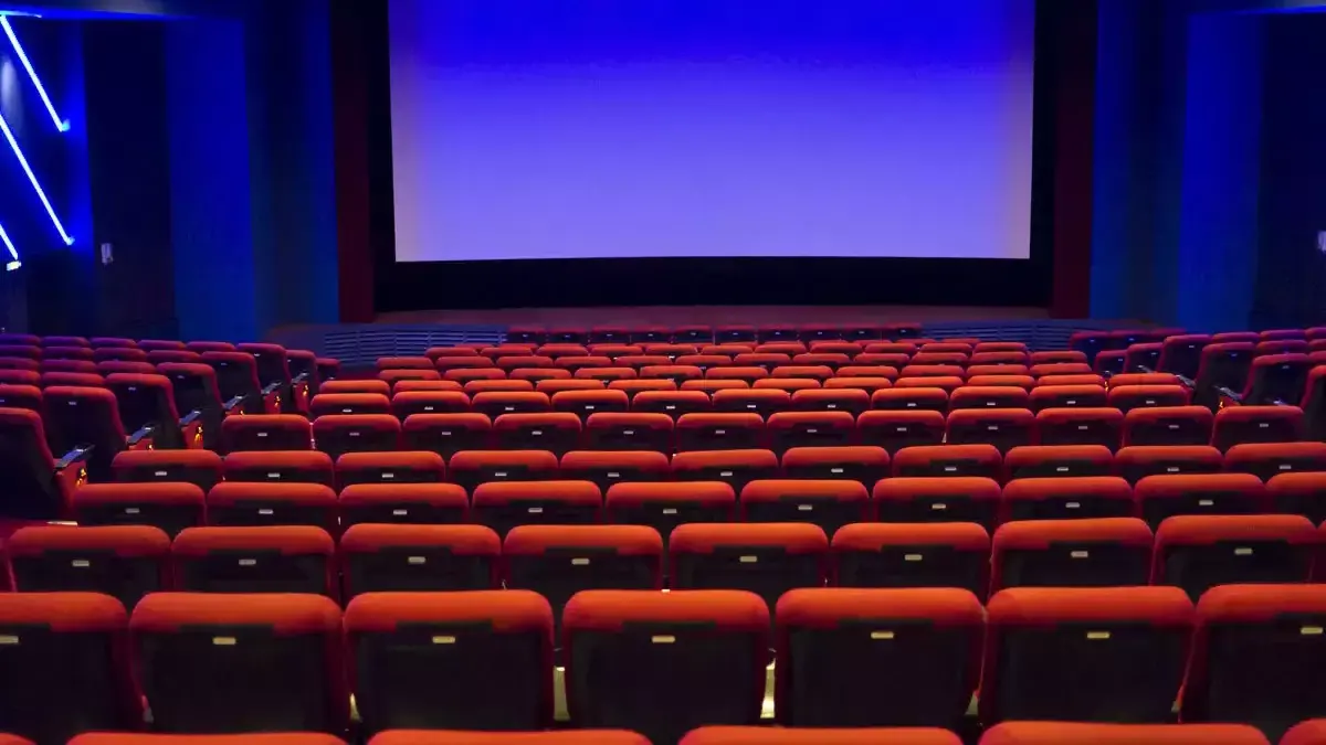Rows of red seats facing a cinema screen