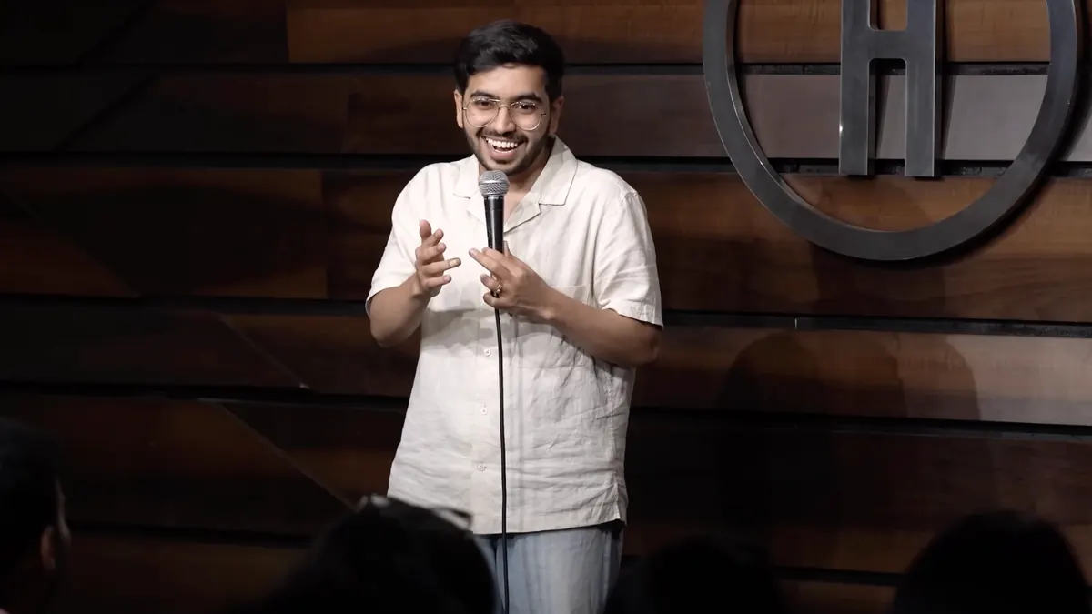A stand-up comedian performing with a microphone
